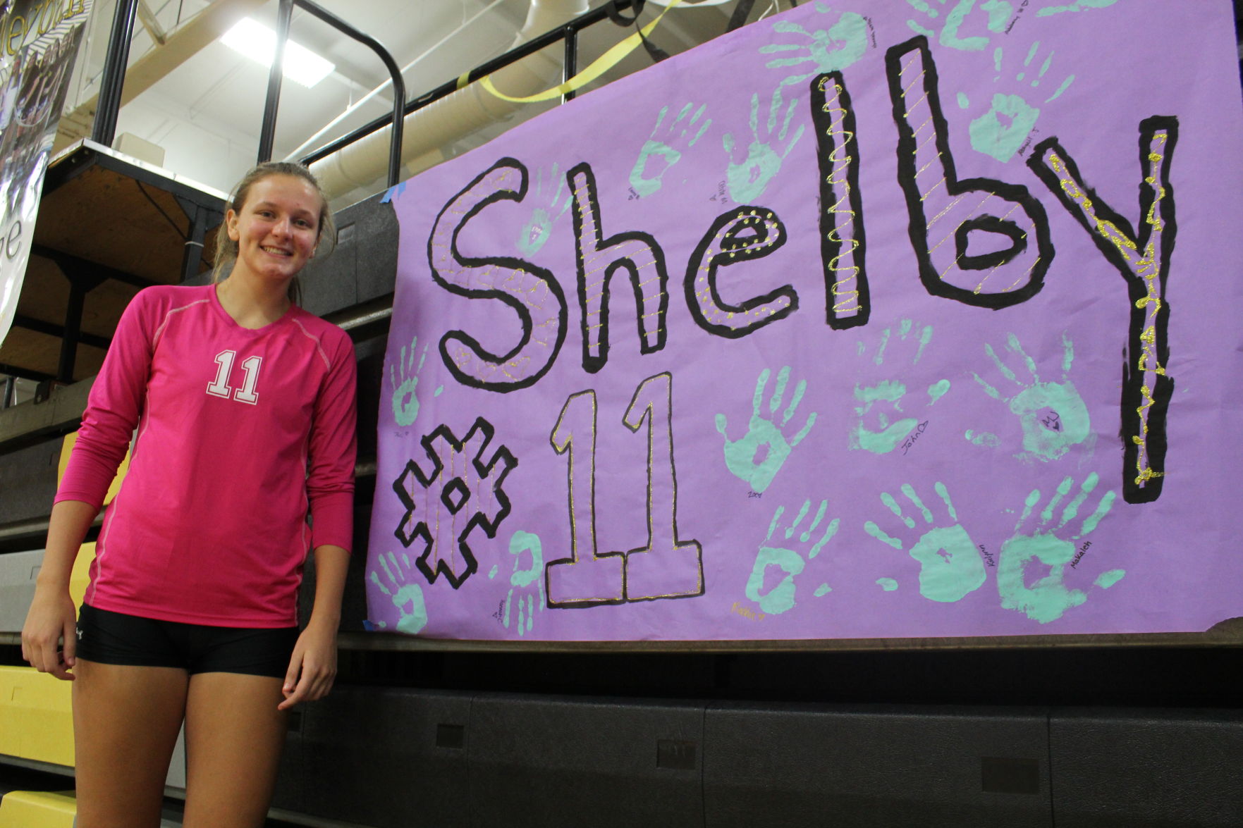 Shelby Glance stands in front of her senior night sign